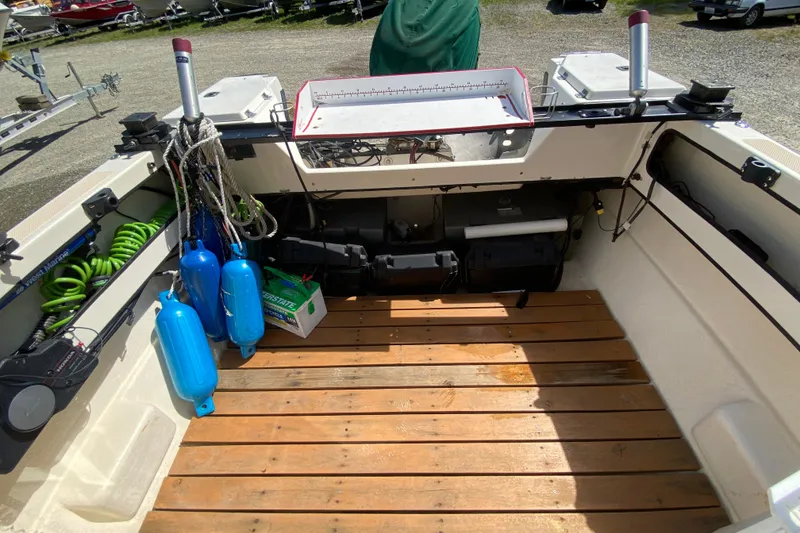 Slide: The Image of Twin outboard motors on a 1999 C-Dory 22' Angler boat, partially covered. - 15
