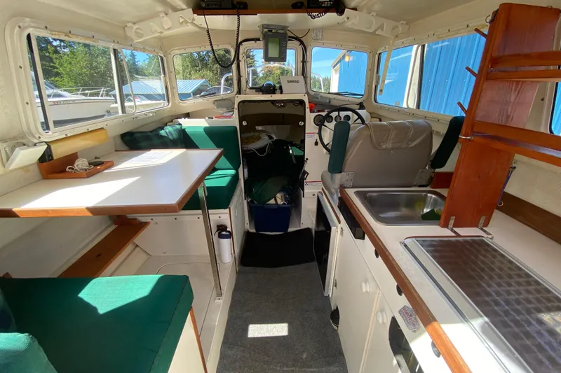 Slide: The Image of Interior of a 1999 C-Dory 22' Angler boat with steering wheel and navigation equipment. - 4