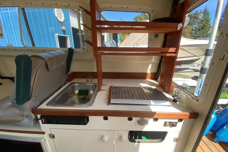 Slide: The Image of Interior of a 1999 C-Dory 22' Angler with navigation equipment and windows. - 6