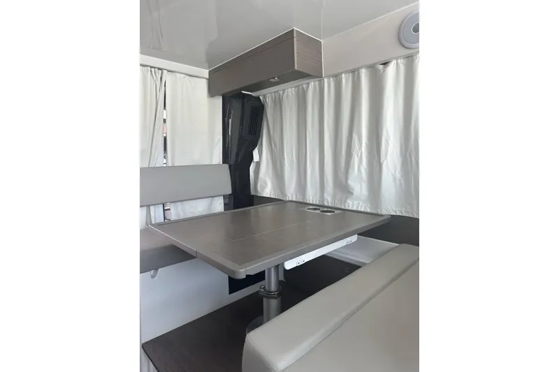Slide: The Image of Interior of 2024 Jeanneau NC Weekender 1095 Fly, featuring a modern dining area. - 10