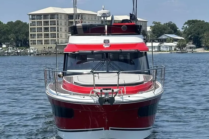 Slide: The Image of 2024 Jeanneau NC Weekender 1095 Fly in vibrant red on calm waters. - 4