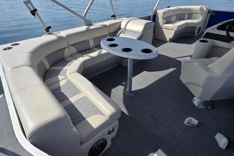 Slide: The Image of Luxurious seating area on a 2022 Lexington 320 boat, featuring plush upholstery and a central table. - 16