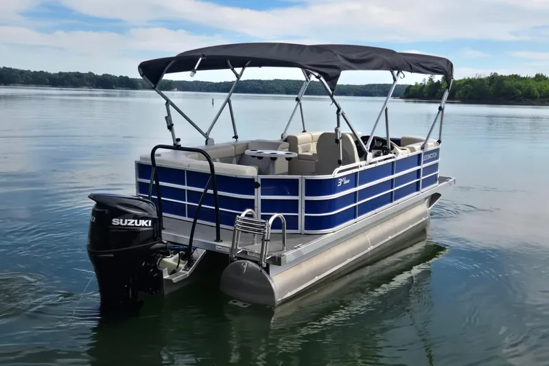 Slide: The Image of 2022 Lexington 320 pontoon boat with Suzuki motor on a calm lake. - 8