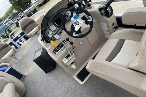 Slide: The Image of 2016 Sun Tracker Fishin' Barge 24 XP3 boat interior with steering console and seating. - 3