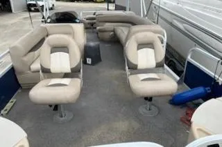 Slide: The Image of 2016 Sun Tracker Fishin' Barge 24 XP3 interior with beige seating and spacious layout. - 6