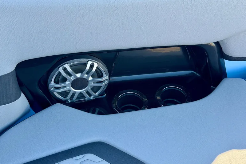 Slide: The Image of Interior of 2025 Yamaha Boats 255XD featuring speaker and cup holders. - 14