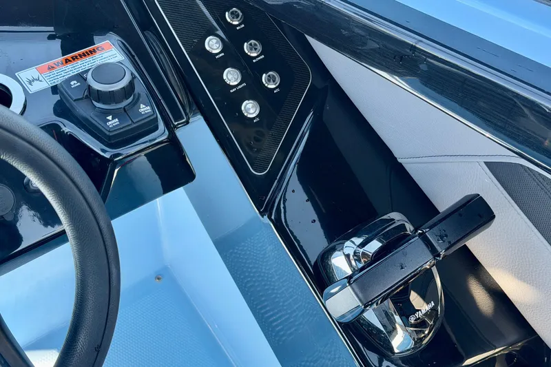 Slide: The Image of Control panel of 2025 Yamaha Boats 255XD, featuring steering wheel and throttle controls. - 22