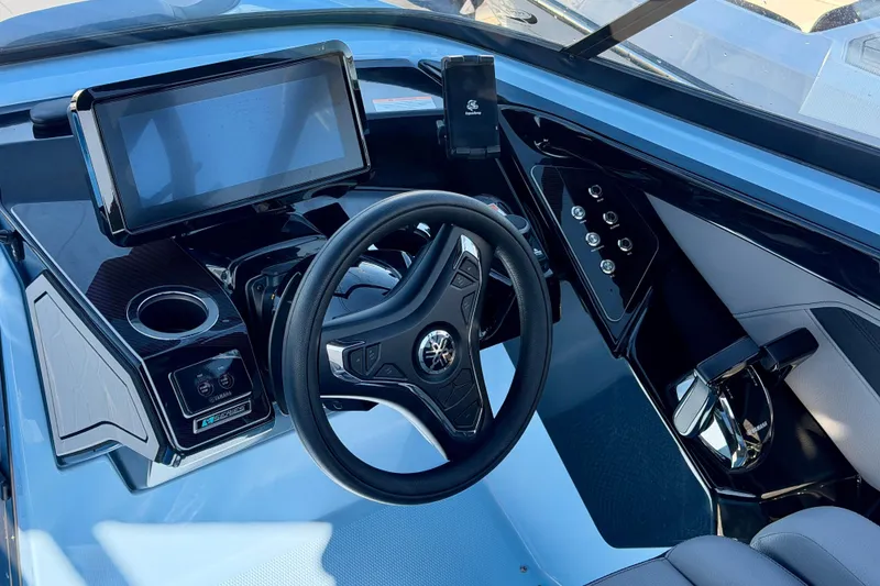 Slide: The Image of 2025 Yamaha Boats 255XD dashboard with modern steering wheel and touchscreen display. - 23