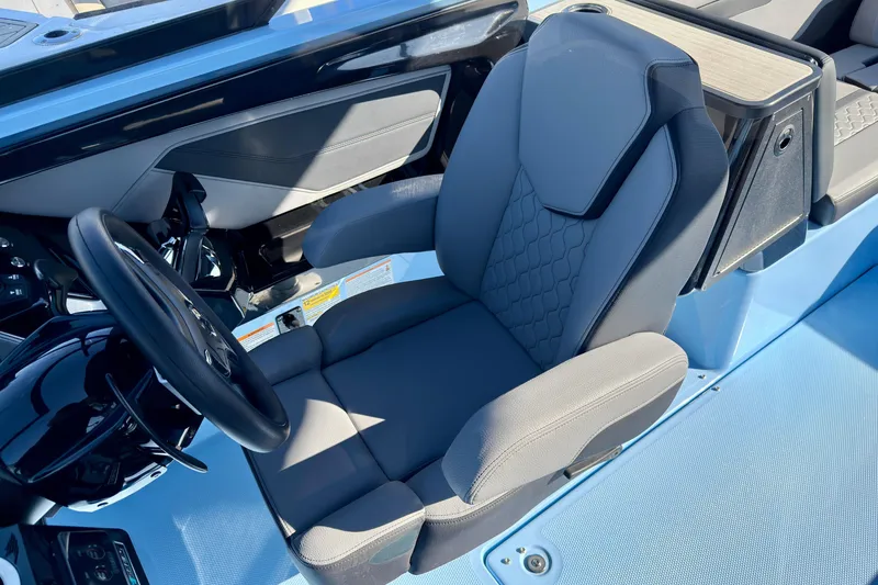 Slide: The Image of 2025 Yamaha Boats 255XD cockpit with sleek steering wheel and comfortable seating. - 25