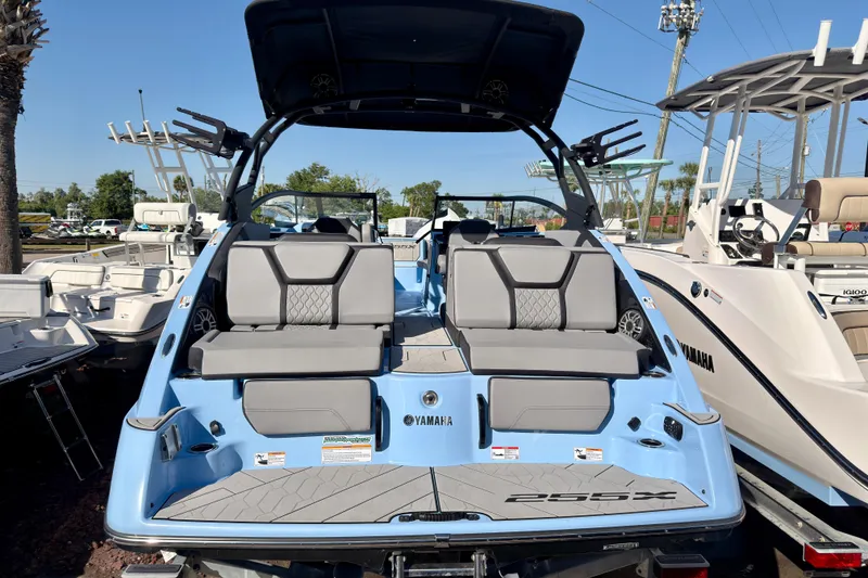 Slide: The Image of 2025 Yamaha Boats 255XD, sleek design, spacious seating, docked outdoors. - 3