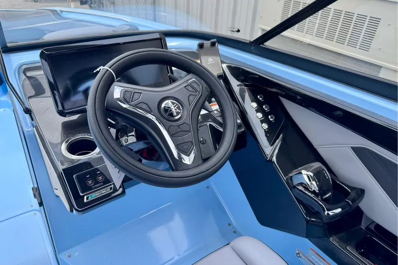 Slide: The Image of 2025 Yamaha Boats 255XD cockpit with modern steering wheel and control panel. - 4