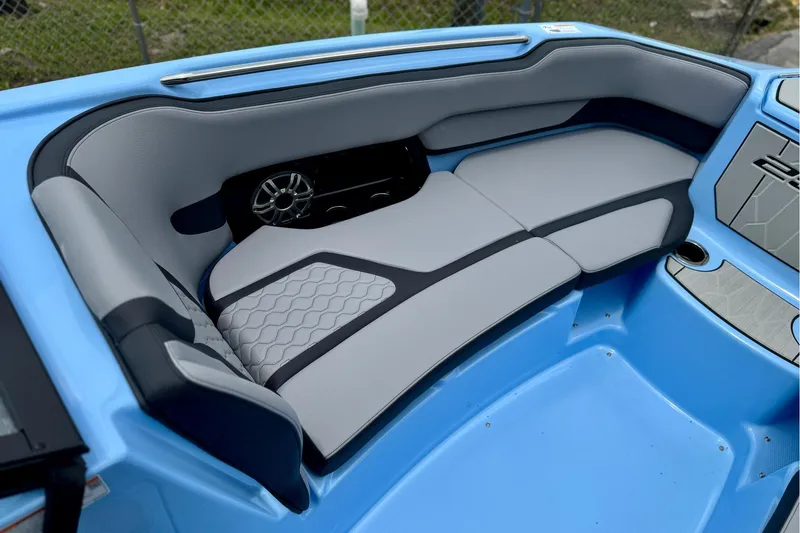 Slide: The Image of 2025 Yamaha Boats 255XD interior with blue and gray seating, featuring modern design elements. - 7