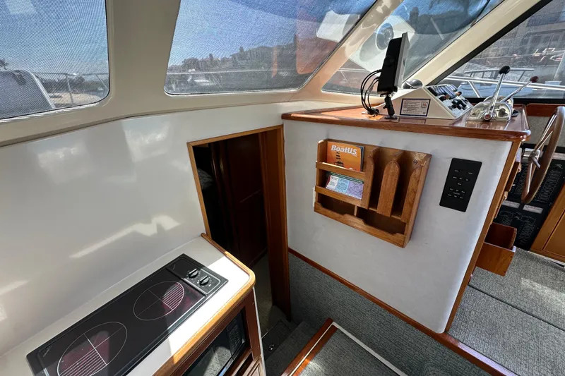 Slide: The Image of Interior of 1999 Riviera 3600 Sport Yacht with stove and helm controls. - 14