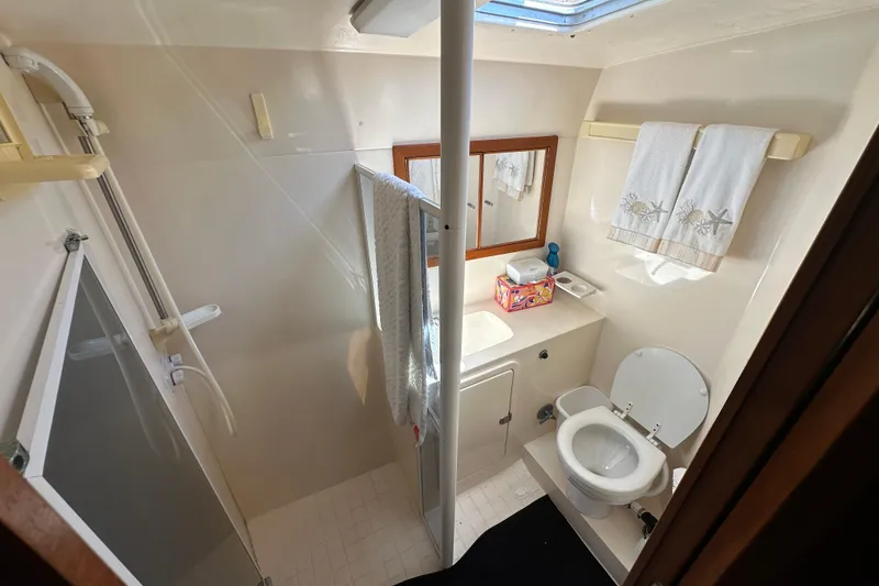 Slide: The Image of Bathroom interior of 1999 Riviera 3600 Sport Yacht with shower, toilet, and sink. - 18