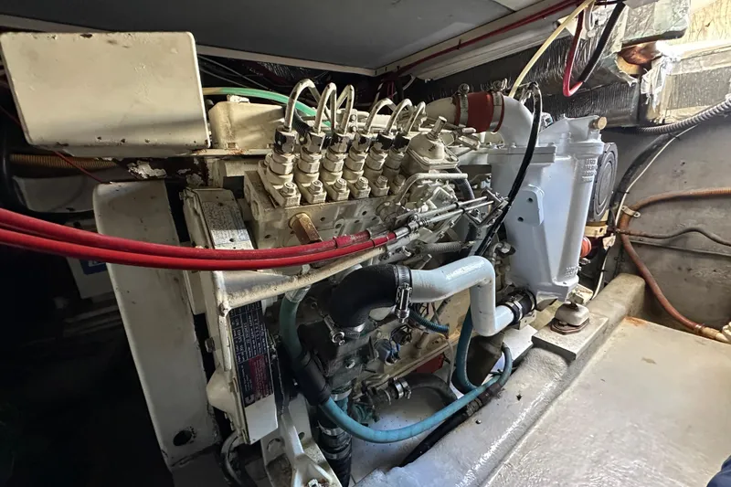 Slide: The Image of Engine compartment of a 1999 Riviera 3600 Sport Yacht, showcasing mechanical components and wiring. - 21