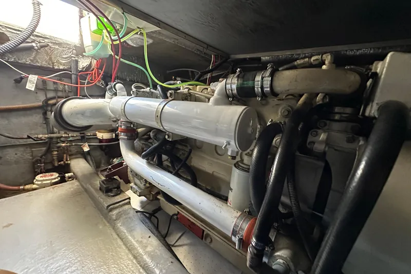 Slide: The Image of Engine room of a 1999 Riviera 3600 Sport Yacht with visible wiring and components. - 22