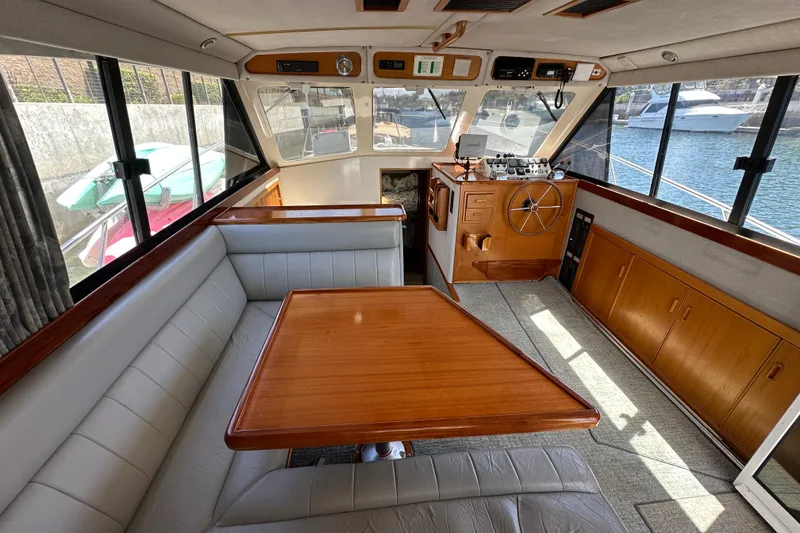 Slide: The Image of Interior of 1999 Riviera 3600 Sport Yacht with wood accents and spacious seating area. - 4