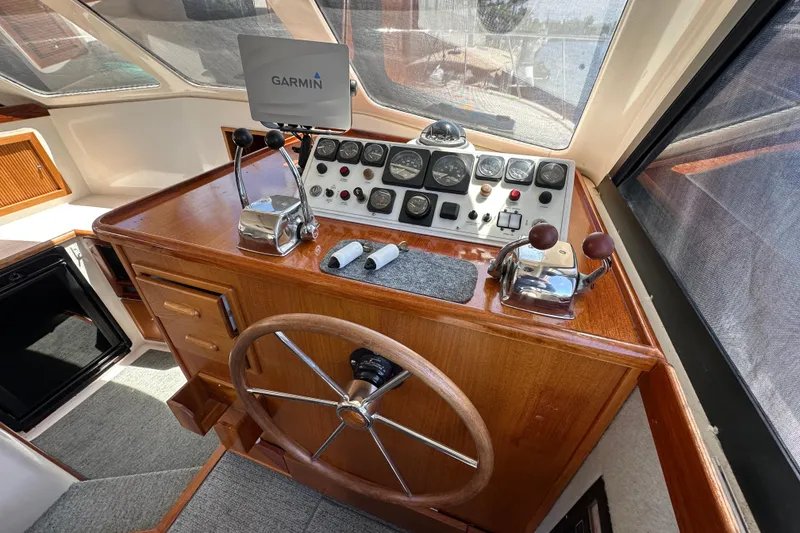 Slide: The Image of Helm of 1999 Riviera 3600 Sport Yacht with Garmin navigation system and classic wooden steering wheel. - 7