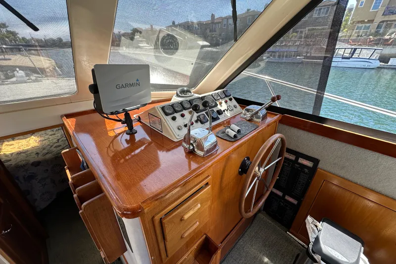 Slide: The Image of Cockpit of 1999 Riviera 3600 Sport Yacht with Garmin navigation system and wooden steering wheel. - 8
