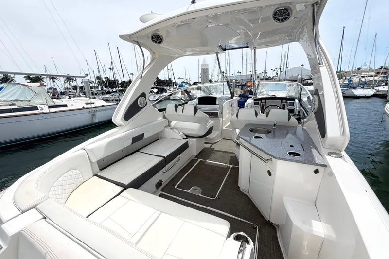 Slide: The Image of 2014 Chaparral 327 SSX boat interior with seating and kitchenette at marina. - 12