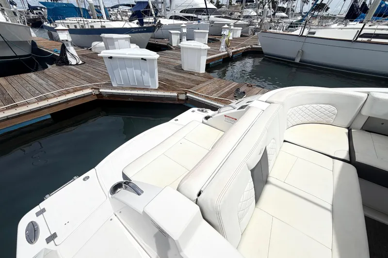 Slide: The Image of 2014 Chaparral 327 SSX boat with white seating at marina dock. - 15