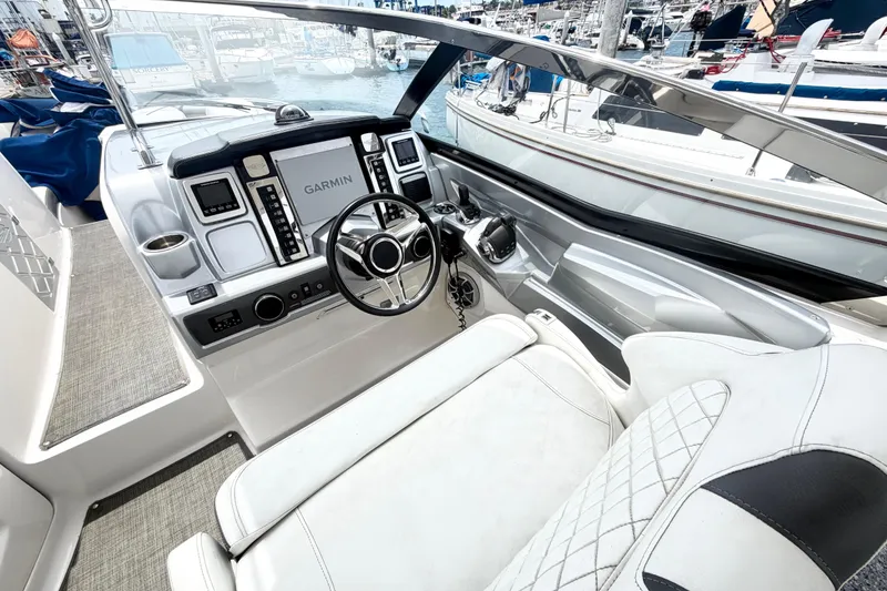 Slide: The Image of 2014 Chaparral 327 SSX boat cockpit with Garmin navigation system and luxurious seating. - 17