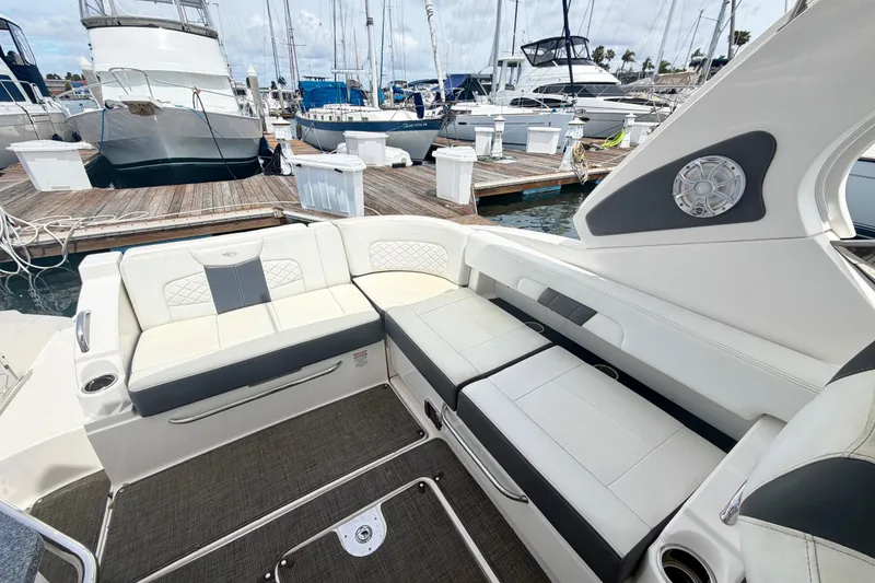 Slide: The Image of Luxurious seating area on a 2014 Chaparral 327 SSX boat docked at a marina. - 18