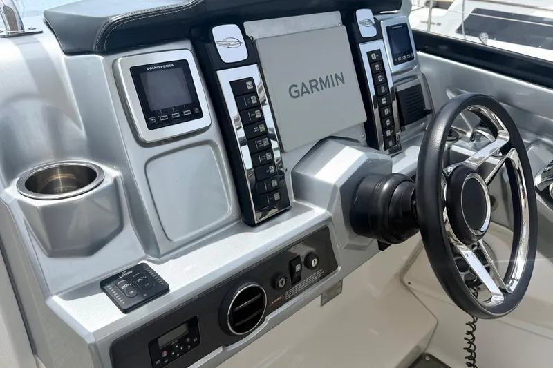Slide: The Image of Control panel of a 2014 Chaparral 327 SSX boat featuring Garmin navigation system. - 21
