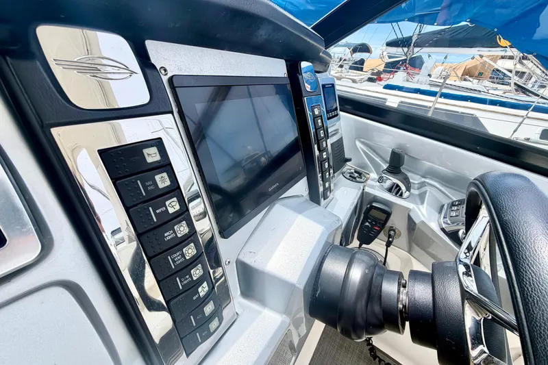 Slide: The Image of Cockpit of 2014 Chaparral 327 SSX boat with modern controls and navigation display. - 23
