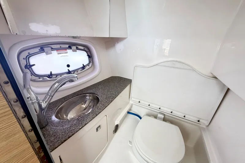 Slide: The Image of 2014 Chaparral 327 SSX boat bathroom with sink, faucet, and toilet. - 29