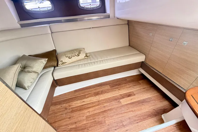 Slide: The Image of Interior of 2014 Chaparral 327 SSX boat with beige seating and wooden flooring. - 30