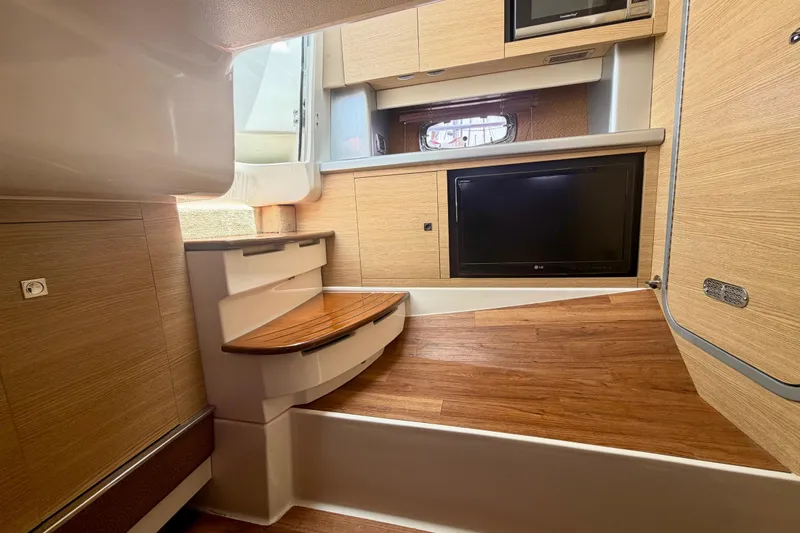 Slide: The Image of Interior of 2014 Chaparral 327 SSX boat with wood flooring and modern amenities. - 32