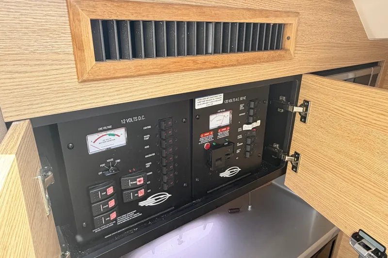 Slide: The Image of Electrical panel inside 2014 Chaparral 327 SSX boat, featuring voltage controls and switches. - 34