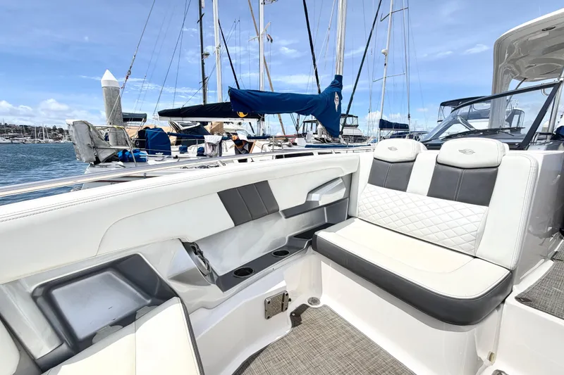Slide: The Image of 2014 Chaparral 327 SSX boat interior with luxurious seating in a marina setting. - 35