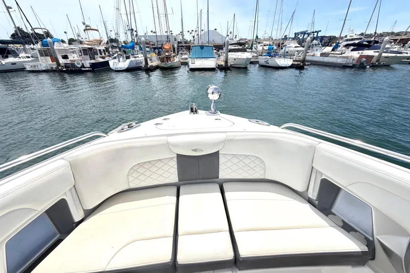 Slide: The Image of 2014 Chaparral 327 SSX boat interior with marina view, showcasing luxurious seating. - 36