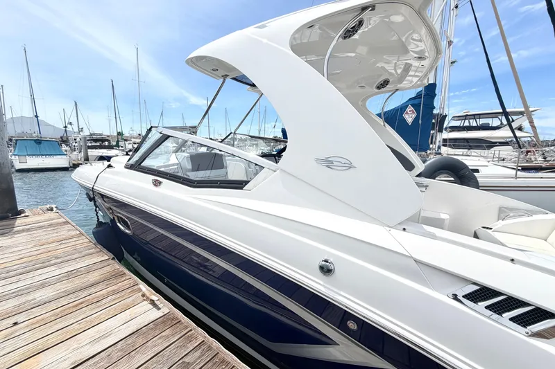 Slide: The Image of 2014 Chaparral 327 SSX boat docked at marina under clear blue sky. - 5