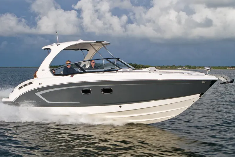 Slide: The Image of Manufacturer Provided Image: 2014 Chaparral 327 SSX boat cruising on water under cloudy sky. - 7