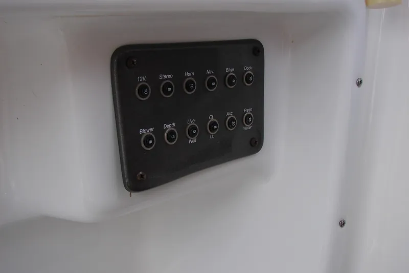 Slide: The Image of Control panel of a 2017 Hurricane SunDeck Sport 202 IO boat, featuring various switches. - 12