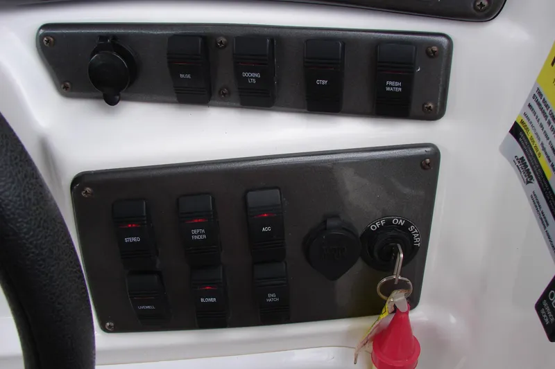 Slide: The Image of Control panel of a 2017 Hurricane SunDeck Sport 202 IO boat with switches and ignition key. - 17