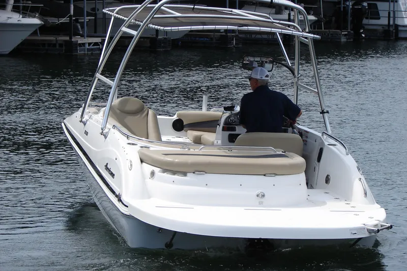 Slide: The Image of 2017 Hurricane SunDeck Sport 202 IO boat cruising on a calm lake. - 2