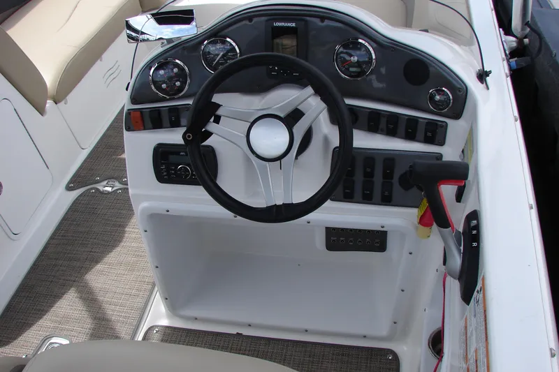 Slide: The Image of 2017 Hurricane SunDeck Sport 202 IO boat dashboard with steering wheel and control panel. - 20