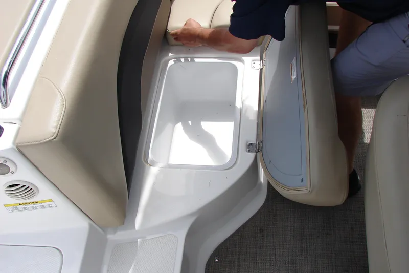 Slide: The Image of 2017 Hurricane SunDeck Sport 202 IO boat interior storage compartment with beige seating. - 21