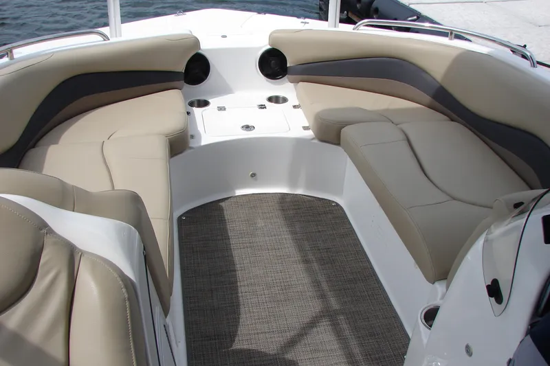 Slide: The Image of 2017 Hurricane SunDeck Sport 202 IO boat interior with beige seating and carpeted floor. - 22