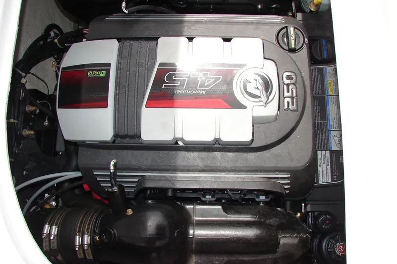 Slide: The Image of Engine compartment of a 2017 Hurricane SunDeck Sport 201 IO boat, featuring a MerCruiser 4.5L 250 engine. - 24