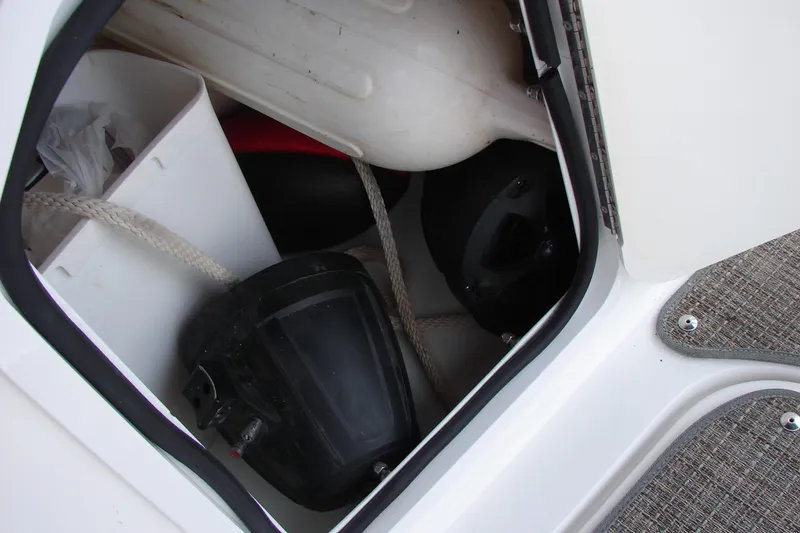 Slide: The Image of Storage compartment in a 2017 Hurricane SunDeck Sport 202 IO boat, containing ropes and equipment. - 28
