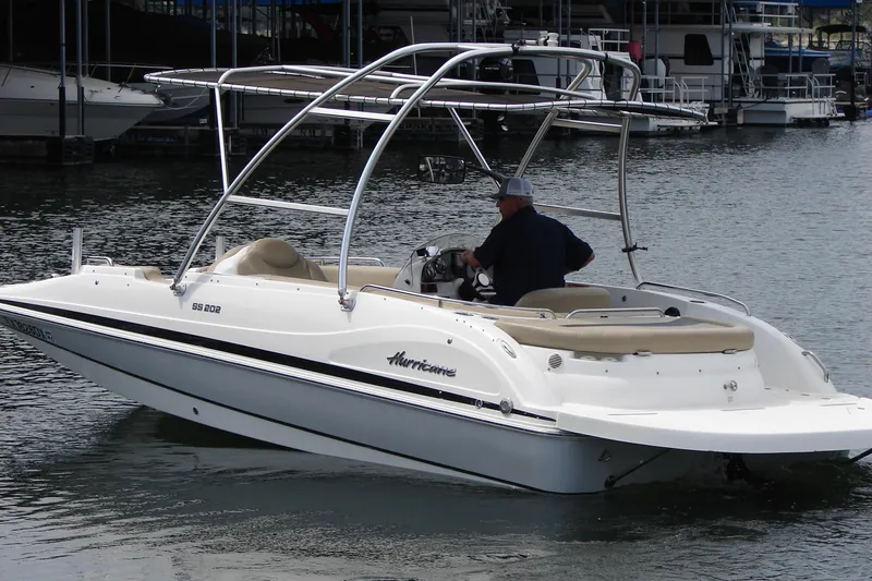 Slide: The Image of 2017 Hurricane SunDeck Sport 202 IO boat on water, featuring sleek design and spacious seating. - 3