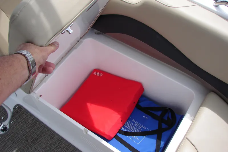 Slide: The Image of Storage compartment in 2017 Hurricane SunDeck Sport 202 IO boat with safety gear. - 30