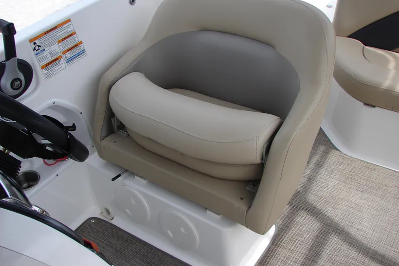 Slide: The Image of Captain's seat in 2017 Hurricane SunDeck Sport 202 IO boat, featuring beige upholstery. - 37
