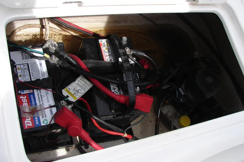 Slide: The Image of 2017 Hurricane SunDeck Sport 202 IO boat battery compartment with wiring and components. - 41