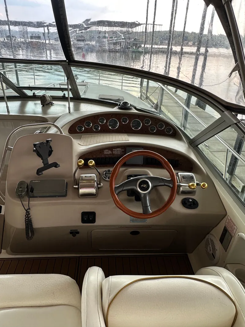 Slide: The Image of 1999 Sea Ray 340 Sundancer cockpit with wooden steering wheel. - 11
